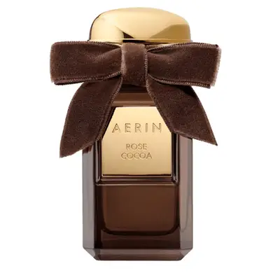 Brown and gold fragrance bottle with a brown velvet bow