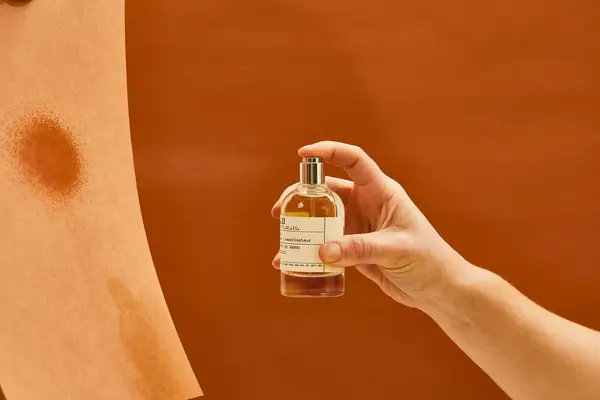 A person sprays Le Labo Santal 33 Eau de Parfum onto paper