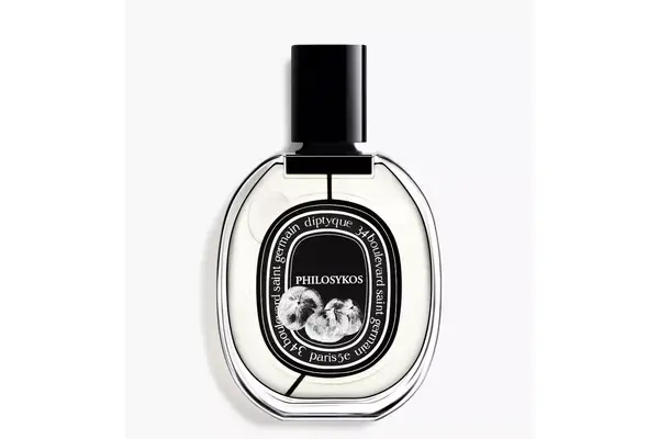 A hand spraying Maison Francis Kurkdjian Baccarat Rouge 540 Eau de Parfum onto fabric