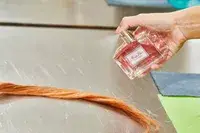 A person sprays DIOR Miss Dior Eau de Parfum on hair