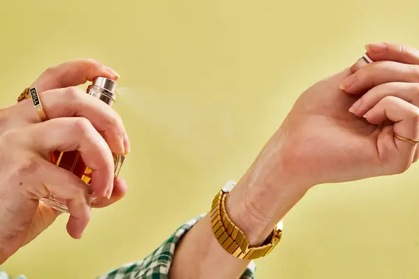 A person sprays Viktor & Rolf Flowerbomb onto their wrist