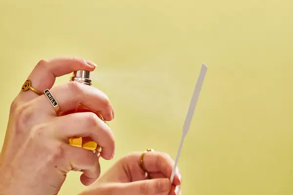 A person sprays Viktor & Rolf Flowerbomb onto a paper test strip