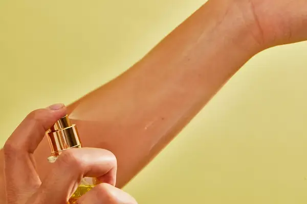 A person sprays Creed Aventus for Her onto their wrist