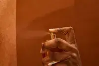 A person sprays Maison Francis Kurkdjian Baccarat Rouge 540 Eau de Parfum