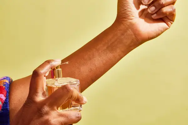 A hand spraying Maison Francis Kurkdjian Baccarat Rouge 540 Eau de Parfum onto their wrist