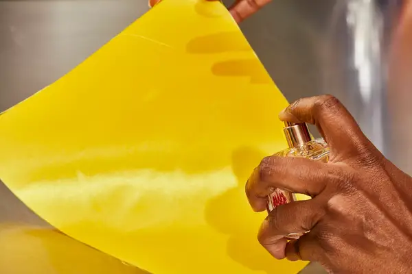 A hand spraying Maison Francis Kurkdjian Baccarat Rouge 540 Eau de Parfum onto fabric