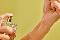 A person sprays Jo Malone Wood Sage and Sea Salt