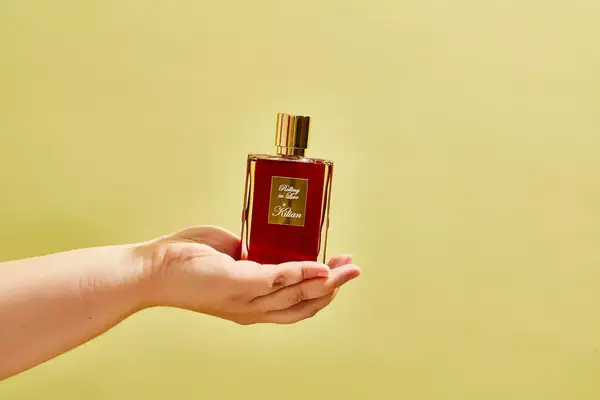 A person holds a bottle of Killian Paris Rolling In Love