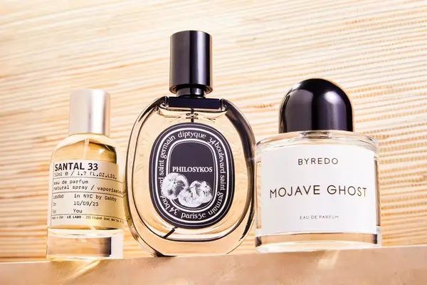 A collage of luxury perfumes we recommend including Le Labo Santal 33, Byredo Mojave Ghost Eau de Parfum and Diptyque Philosykos