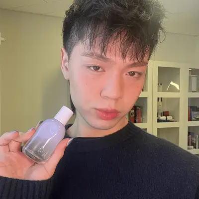 MYM Beauty editor holding Glossier You Fleur
