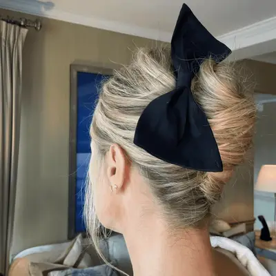 carolyn murphy wearing french twist with a bow