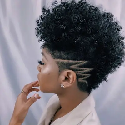 woman with curly mohawk and razor cut design