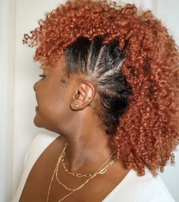Side view of woman with red curly mohawk