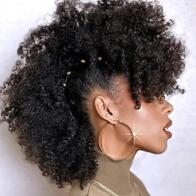 Side view of woman with long pinned curly faux hawk