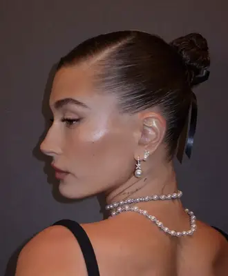 Hailey Bieber wears an Audrey Hepburn inspired updo at a Tiffany & Co. event in NYC