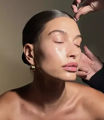 Hailey Bieber gets a hair touch-up on set for Rhode skincare
