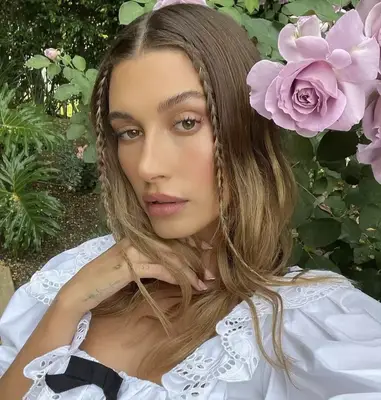 Spring-fresh makeup and face-framing baby braids on Hailey Bieber