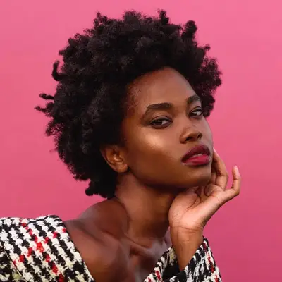 Model wears a natural Afro hairstyle