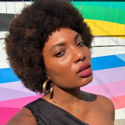 MYM Beauty writer Bianca Lambert wears an Afro hairstyle