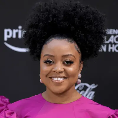 Quinta Brunson wearing sleek afro puff