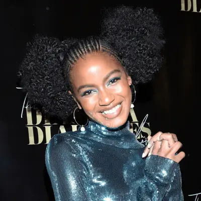 Model Ebonee Davis with cornrows and afro puffs