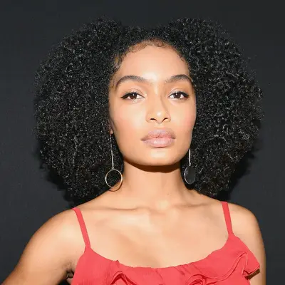 Yara Shahidi wears a parted Afro hairstyle