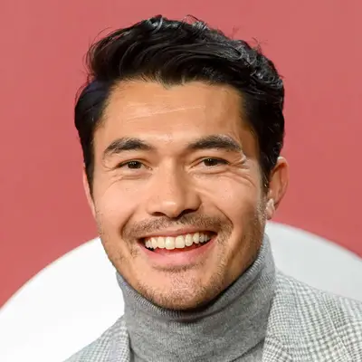 Henry Golding with long, tousled quiff haircut