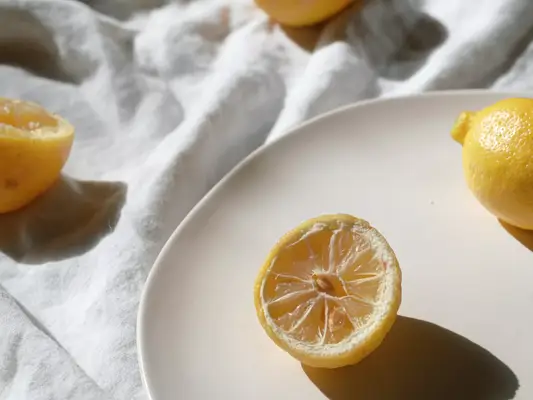 A composed tablescape with full lemons and half lemons