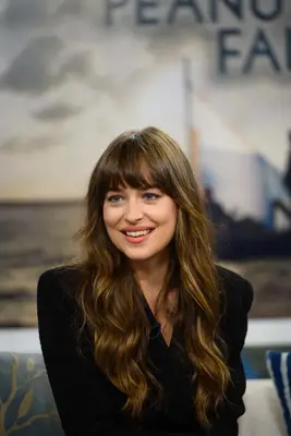 Dakota Johnson sits down for an interview with long wavy hair