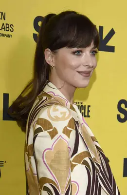Dakota Johnson attends SXSW in a retro pant suit and high ponytail