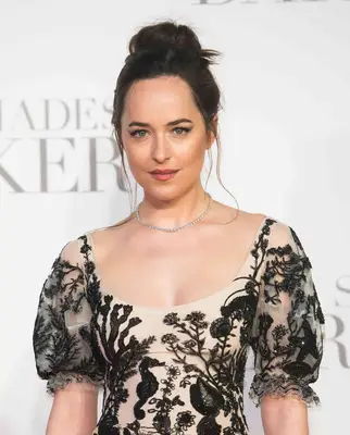 Close up of Dakota Johnson with an updo and hairstyle in a white and black dress