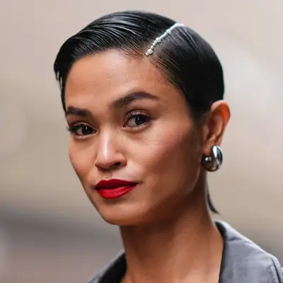 Fashion week attendee wears a gelled pixie with a pearl lined side parting