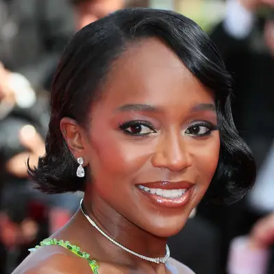 Aja Naomi King attends film premiere at Cannes in a jaw-length bob with side part and retro curled hairline