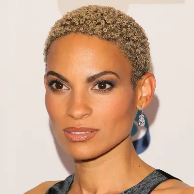 Goapele wears her tightly coiled, bleach blonde texture in a close crop cut 