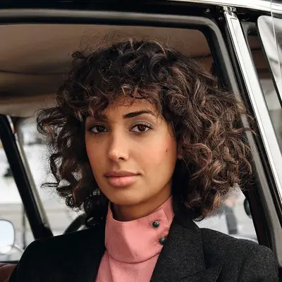 person with curly caramel hair 