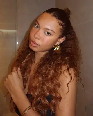 person with long auburn caramel hair