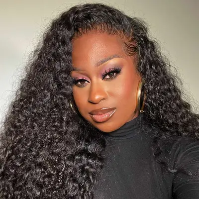 woman wearing black turtleneck with gold hoops and curly hair