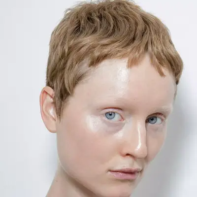 model with strawberry blonde pixie cut hair