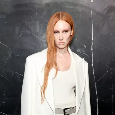 Meredith Duxbury with long and wavy strawberry blonde hair