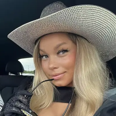 Tanner Adell in a rhinestone cowboy hat with long bleached blonde hair