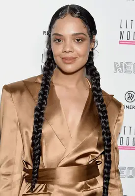 Tessa Thompson with long Dutch braids and slicked-down baby hairs at the 2019 Refinery 29 