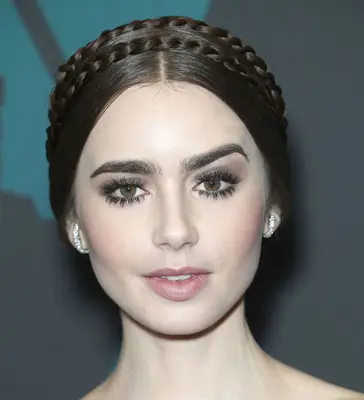Lilly Collins with a sleek braided crown hairstyle at the 2018 Governors Awards in Hollywood, California