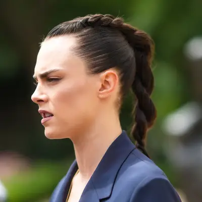 Cara Delevingne with a braided and twisted hairstyle at the Dior Haute Couture Fall/Winter 2021/2022 show in Paris, France