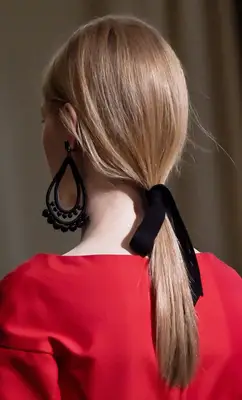 A model with a sleek low blonde ponytail