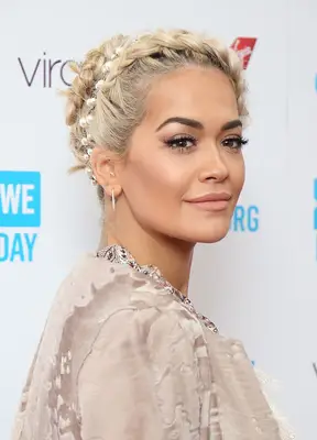 Rita Ora wearing her platinum blonde hair in a crown braid updo