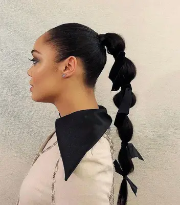Tessa Thompson in a long bubble braid with ribbons