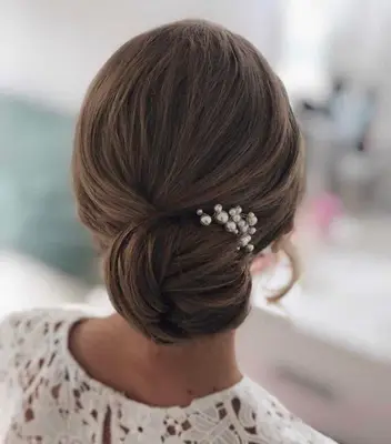 Chic low bun with pearl adornments