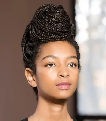 A model wearing a box-braided beehive hairstyle