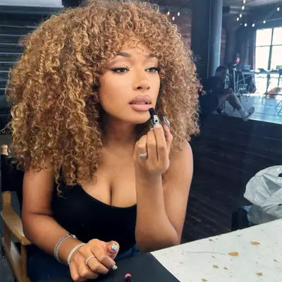 megan thee stallion with caramel curly hair
