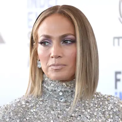 Jennifer Lopez wears dark blonde hair with light golden champagne blonde highlights